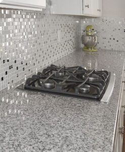 white cabinet new caledonia-gray-granite-countertop glass backsplash tile