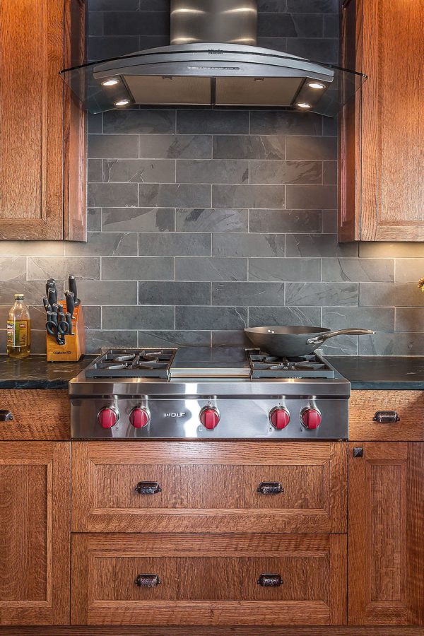 Black countertop brown cabinet with black slate backsplash tile BA1045