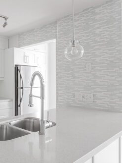white quartz countertop cabinets with white modern backsplash tile 1
