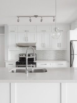white quartz countertop cabinets with white modern backsplash tile 4