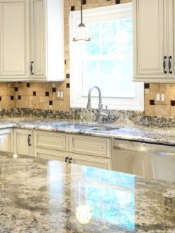 Beige cabinets granite countertop travertine glass backsplash 5 tile BA1043
