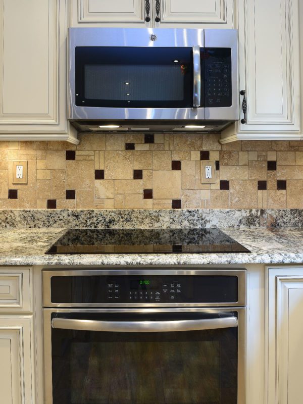 Beige cabinets granite countertop travertine glass backsplash tile 2 BA1043