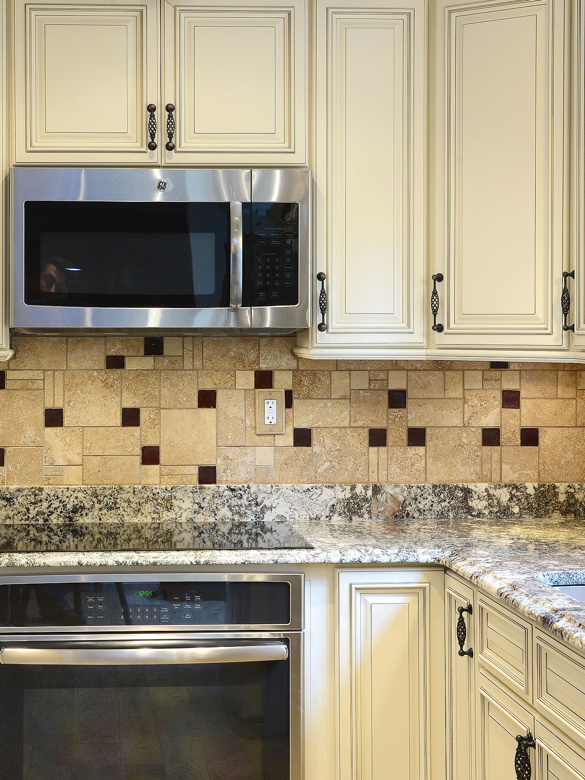 Beige cabinets granite countertop travertine glass backsplash tile 3 BA1043