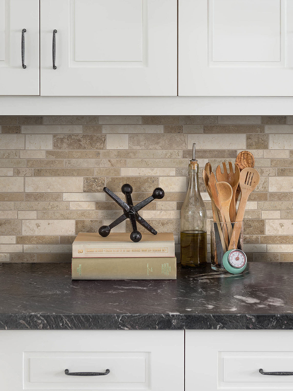 black countertop with white cabinets and travertine backsplash tile