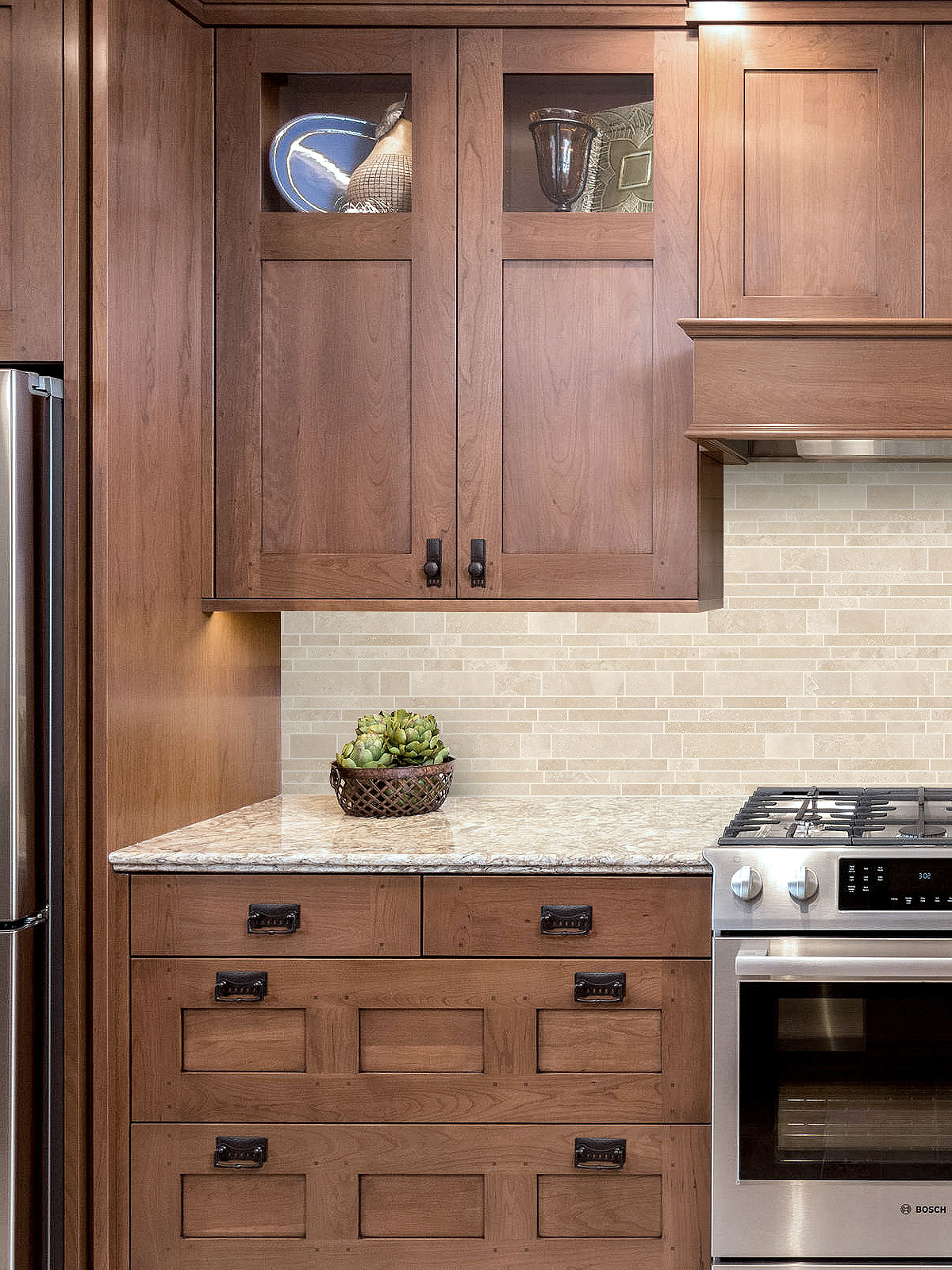 Brown cabinets gold granite countertop travertine backsplash tile