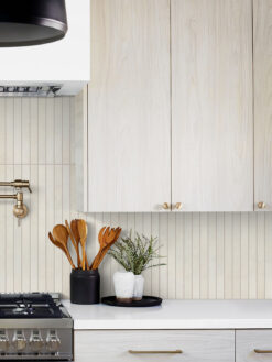 Light Wood Cabinet with Modern Beige Backsplash Tile